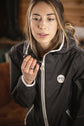 Penelope Fashion Rain equestrian coat with contrasting white zipper details.