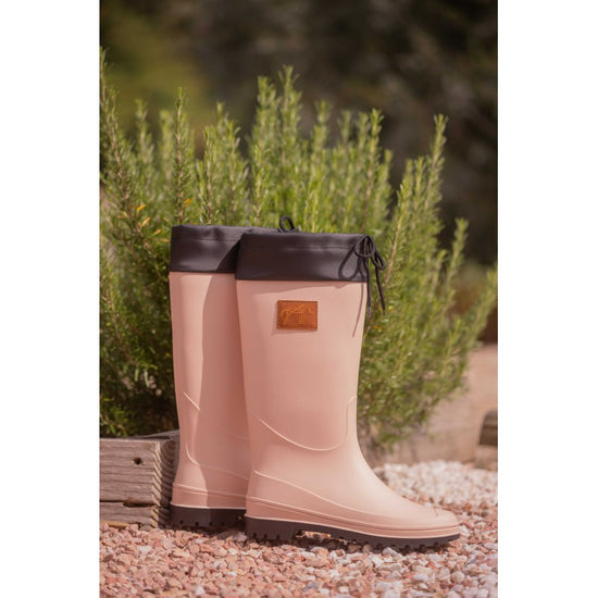 Penelope Jessica pale pink boots with durable construction and branded leather patch detail.