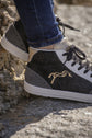 Penelope Jupiter glitter sneakers with black, gold and grey tri-color styling.