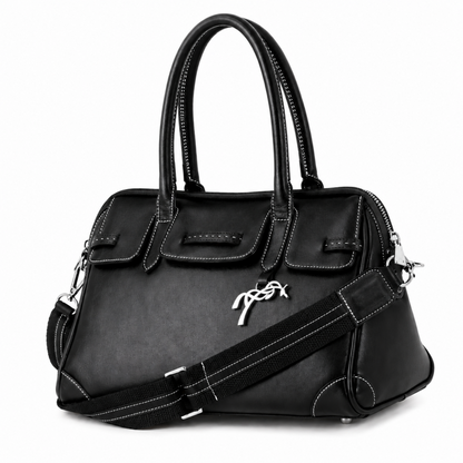 Penelope Maelys bag with decorative silver charm on the front.