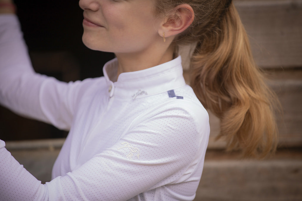 Penelope Seville Mesh junior competition shirt with white officer collar and half zip.