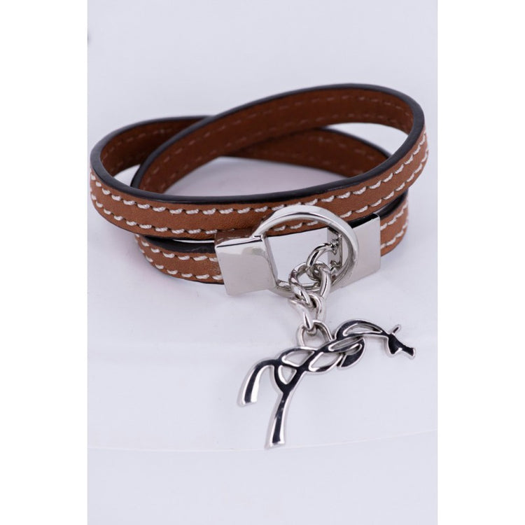 Penelope Signature leather bracelet with white saddle stitching.