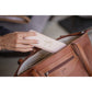 Penelope Toti French leather bag with elegant embossed logo detailing.