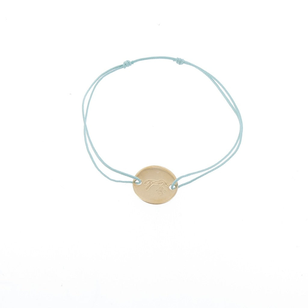 Penelope Zoe Gold Bracelet with delicate cord and round gold-plated horse logo plate