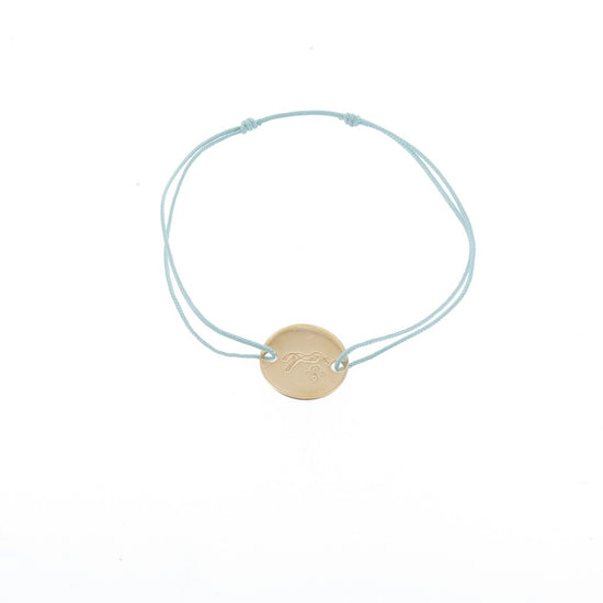 Penelope Zoe Gold Bracelet with delicate cord and round gold-plated horse logo plate
