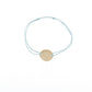Penelope Zoe Gold Bracelet with delicate cord and round gold-plated horse logo plate