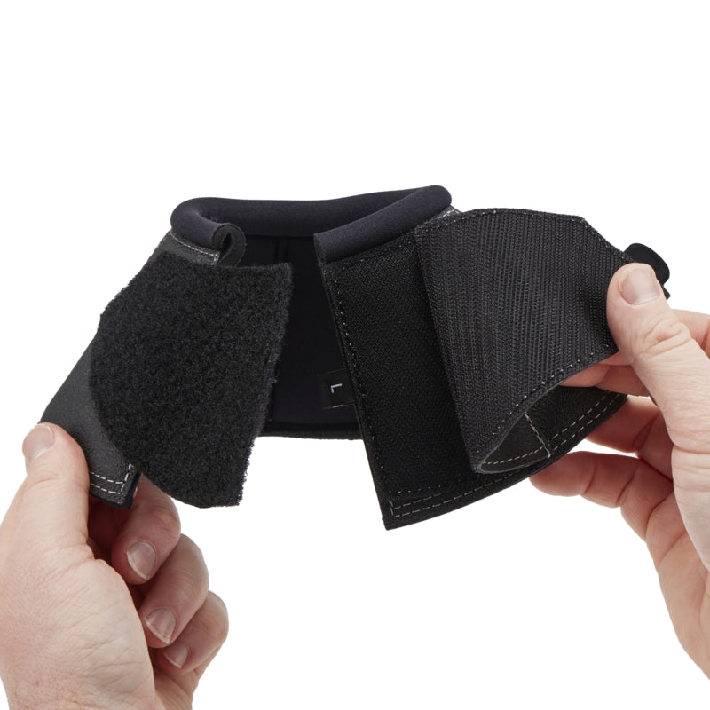 Stübben protective bell boots fitted to a show jumping horse