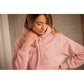 Woman wearing a pink Penelope collection hoodie