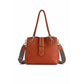 Trapezoid leather handbag with removable shoulder strap