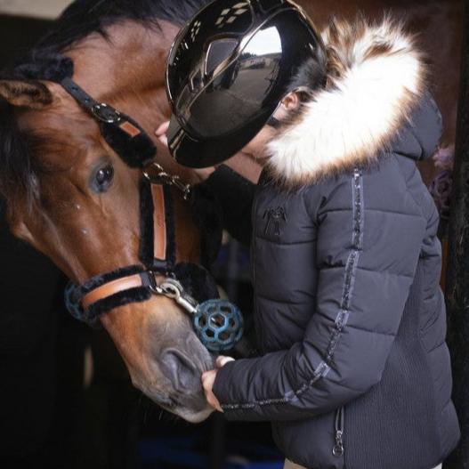 Warm equestrian jacket with large hood and comfortable design for winter riding.