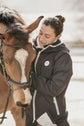 Waterproof horse riding coat with practical rear slit for comfortable movement in the saddle.