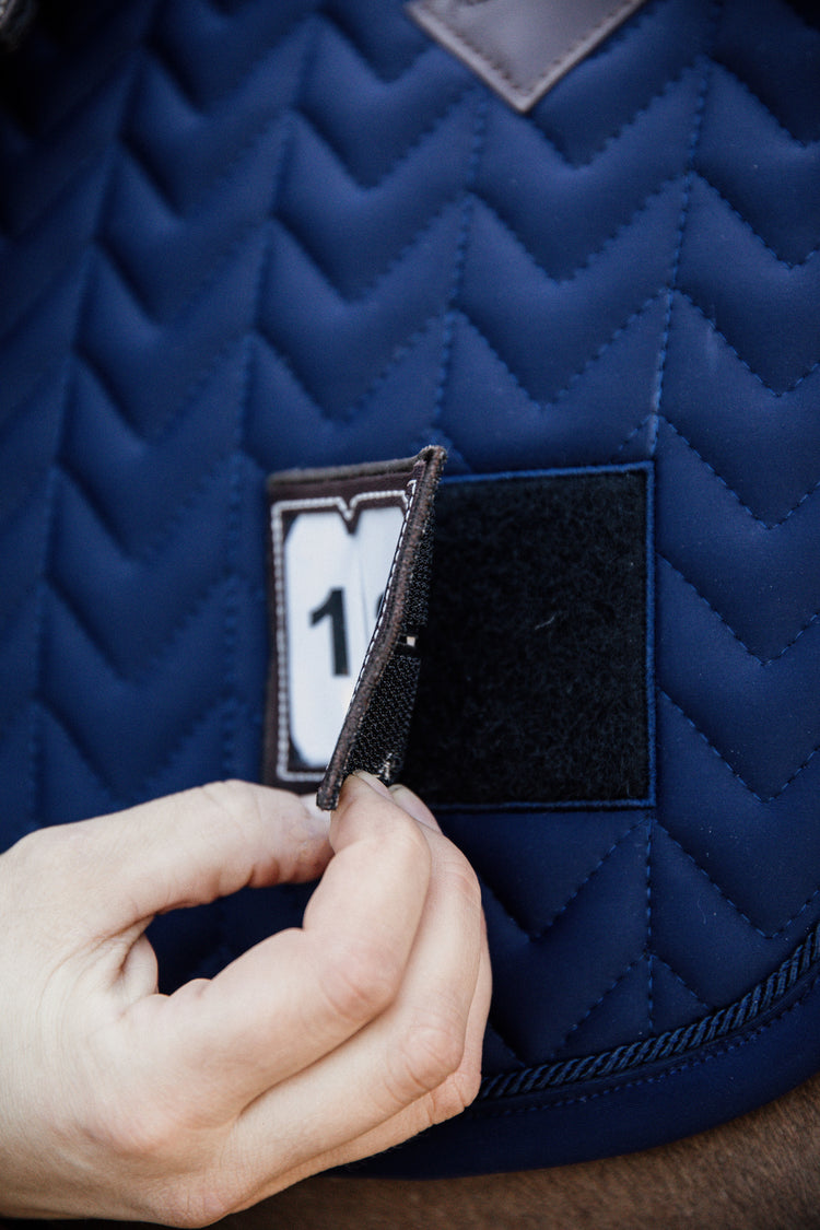 Saddle pad with start number