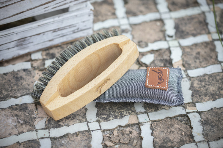 Grooming brush for sensitive horse areas with short soft bristles.