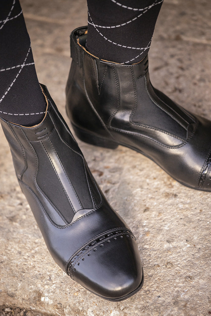 Penelope Celeste leather ankle boots with elegant decorative stitching.