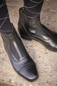 Penelope Celeste leather ankle boots with elegant decorative stitching.