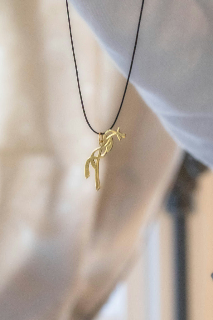 Penelope horse logo necklace with a subtle equestrian design.