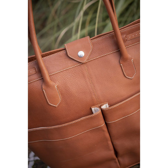 Penelope Maisons Laffitte stable bag with logo badge and practical pockets.