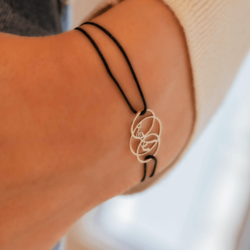 Penelope Lendita Bracelet with delicate black cord and decorative rings.