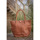 Penelope Maisons Laffitte Grooming Bag made from leather with multiple storage pockets.