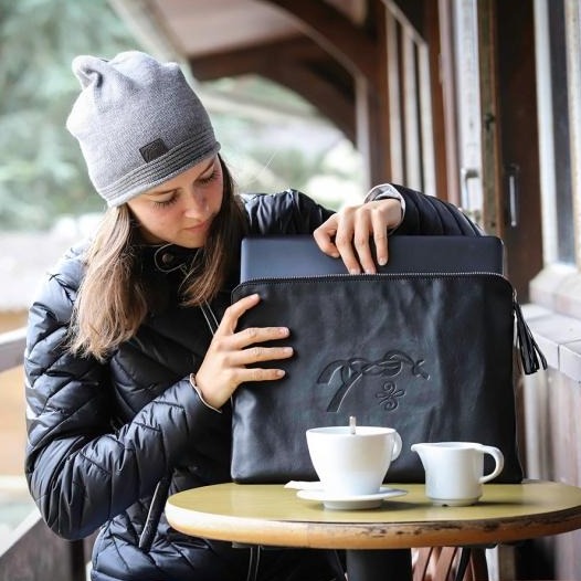 Penelope Thin Pocket Computer Bag made from smooth leather with embossed logo.